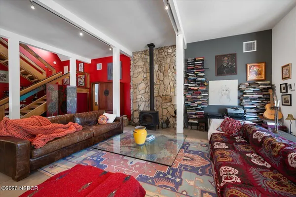 a kitchen with stainless steel appliances granite countertop a sink and a refrigerator
