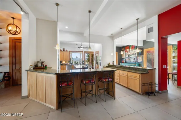 a kitchen with stainless steel appliances kitchen island granite countertop a sink and a granite counter tops