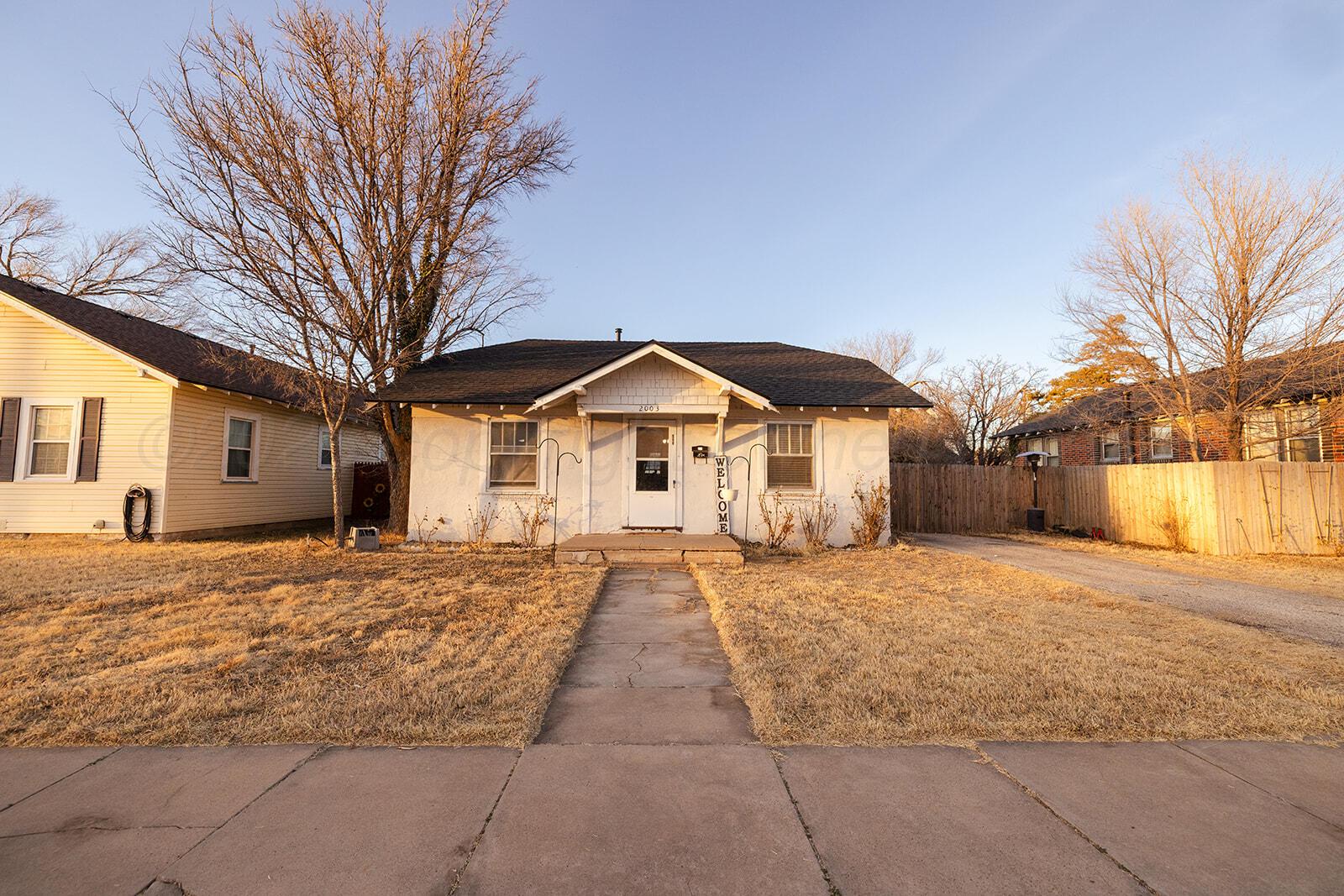 2003 5th Avenue Canyon, TX 79015 - Photo 1 of 19 a front view of a house with a yard and garage