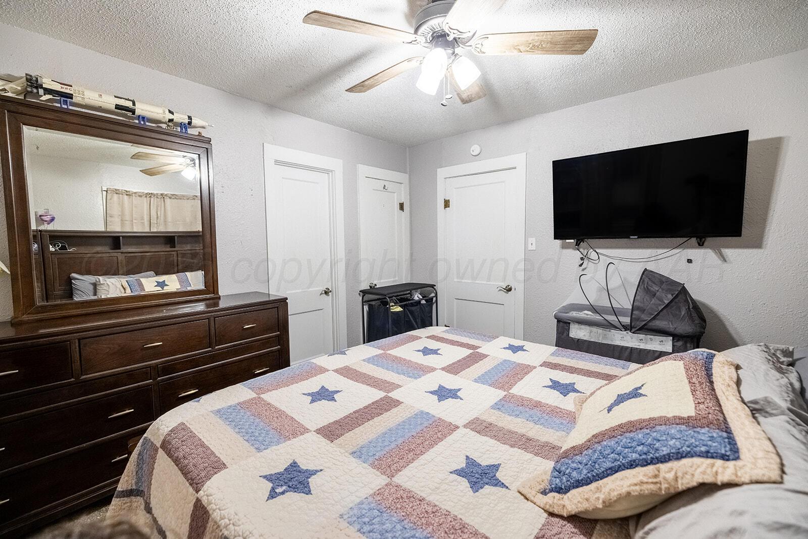 2003 5th Avenue Canyon, TX 79015 - Photo 11 of 19 a bedroom with a bed and a flat screen tv
