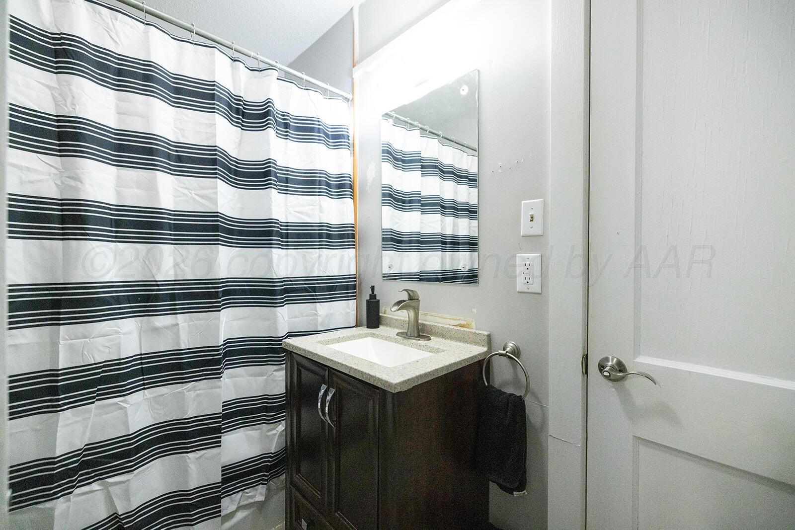 2003 5th Avenue Canyon, TX 79015 - Photo 14 of 19 a bathroom with a sink and a mirror