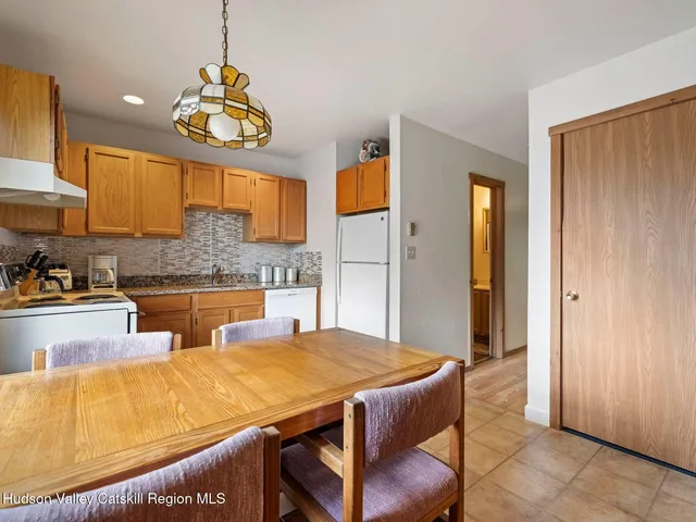a kitchen with stainless steel appliances granite countertop a sink and a refrigerator