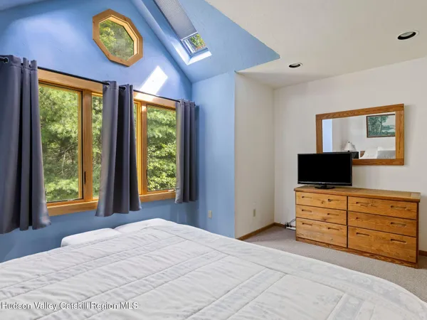 a view of a bedroom with furniture and a window