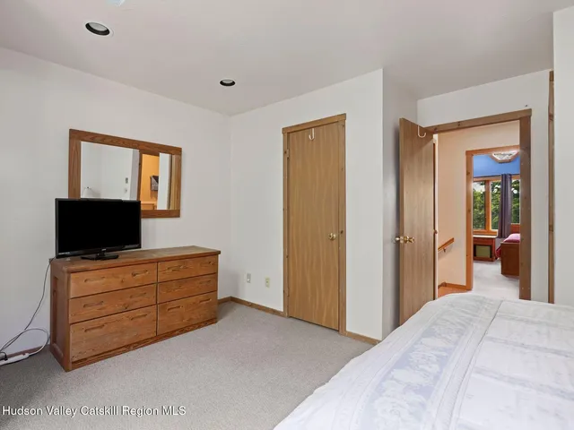 a bedroom with bed and flat screen tv