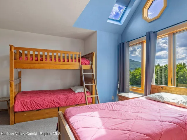 a bedroom with a bed and a large window