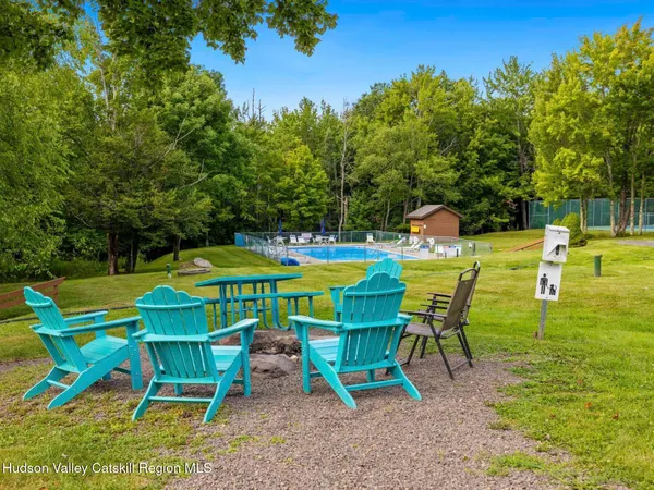 a view of a chairs and table in the backyard
