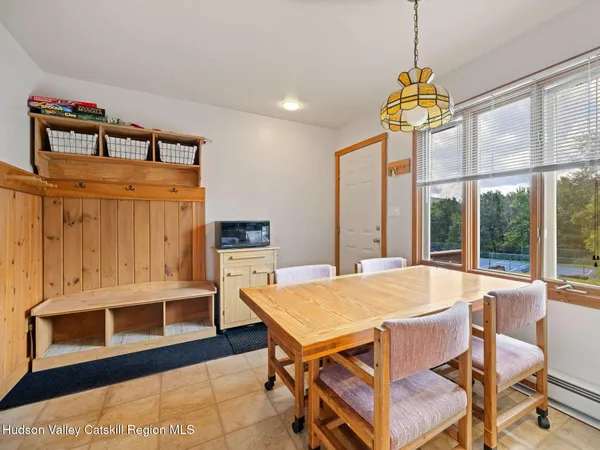 a view of a dining room with furniture a chandelier and wooden floor