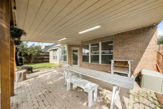 a view of a house with backyard sitting area and garden