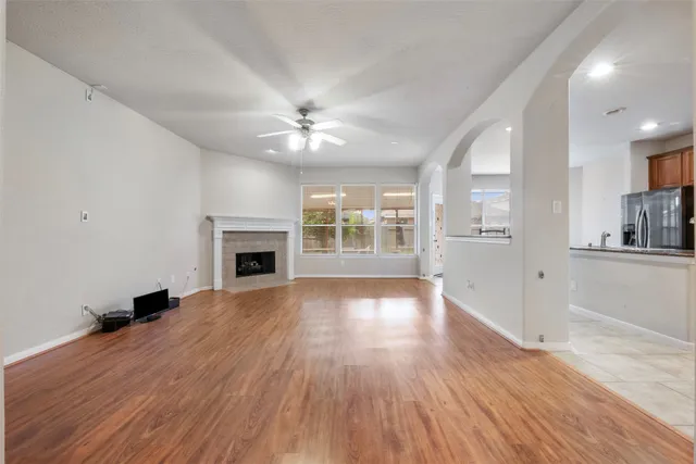 wooden floor in an empty room with a fireplace