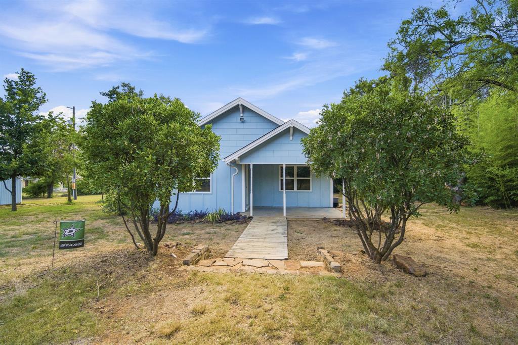 3325 Dove Creek Road Cleburne, TX 76031 - Photo 22 of 40 Light blue exterior with white trim, featuring a covered porch and white porch columns