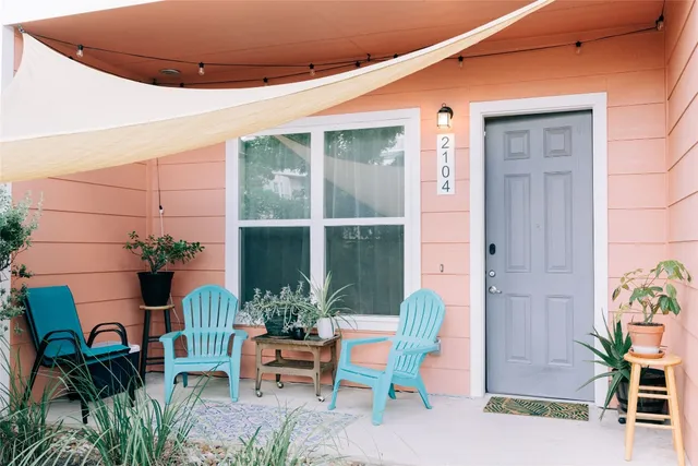 a front view of a house with outdoor seating