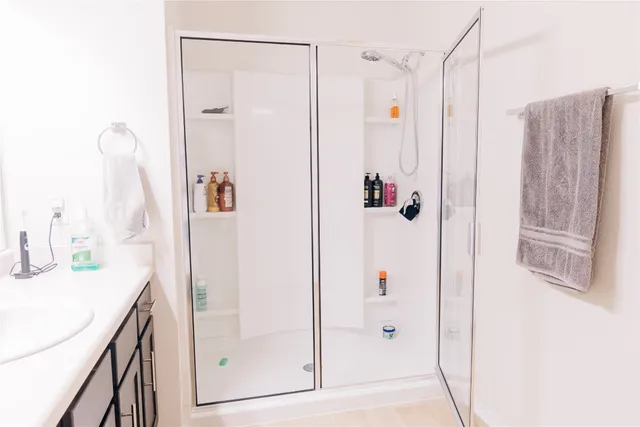 a bedroom with a bed and dresser with mirror