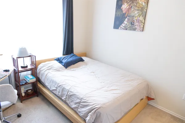 a room with a chair and dresser