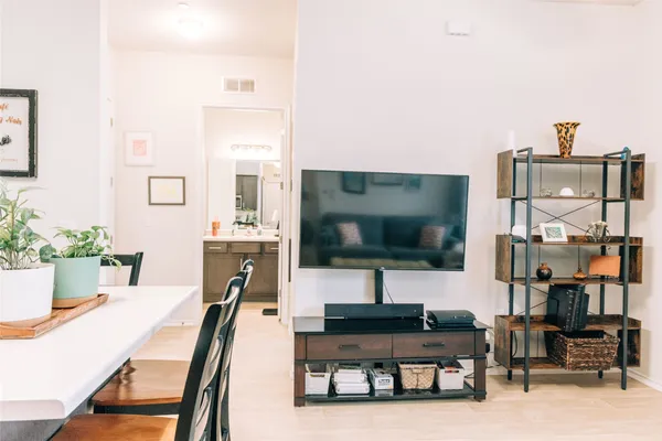 a bedroom with a bed and a large mirror next to a window