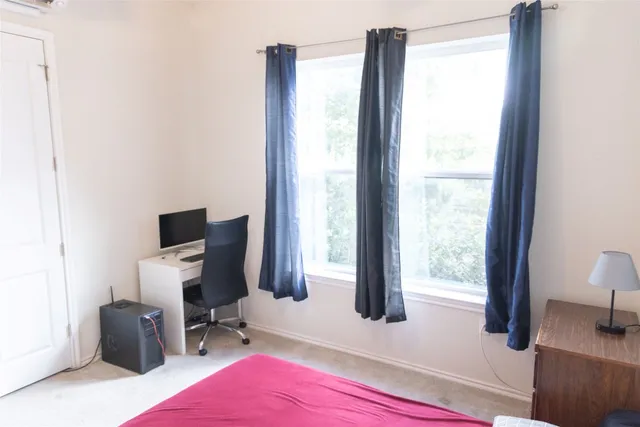 a utility room with dryer washer and a view of living room
