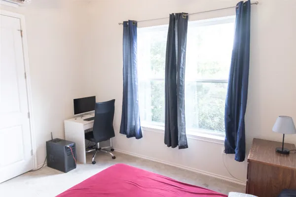a utility room with dryer washer and a view of living room