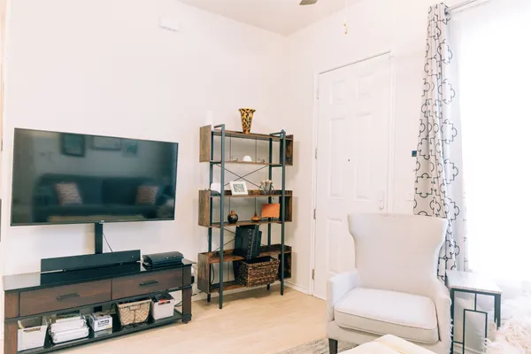 a living room with furniture and a flat screen tv