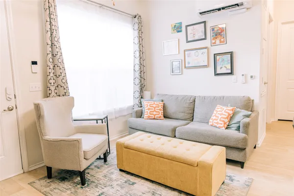 a living room with furniture and a potted plant