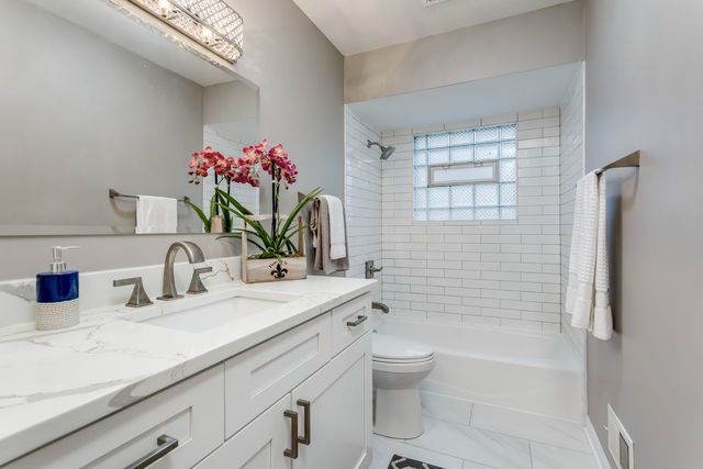 7500 Beckwith Road Morton Grove, IL 60053 - Photo 12 of 27 a bathroom with a granite countertop sink a toilet and shower