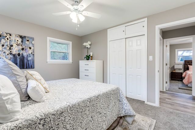 7500 Beckwith Road Morton Grove, IL 60053 - Photo 17 of 27 a bedroom with a bed and a chandelier