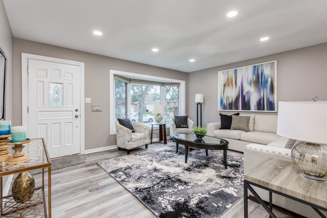 7500 Beckwith Road Morton Grove, IL 60053 - Photo 3 of 27 a living room with furniture and floor to ceiling window