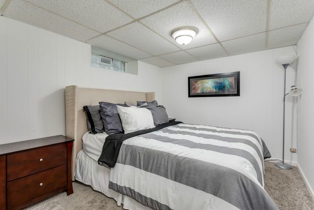 7500 Beckwith Road Morton Grove, IL 60053 - Photo 22 of 27 a bedroom with a bed a painting on the wall and a dresser