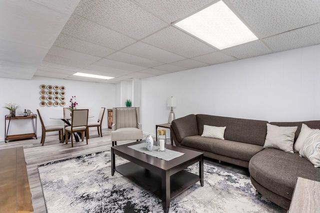 7500 Beckwith Road Morton Grove, IL 60053 - Photo 23 of 27 a living room with furniture and a table