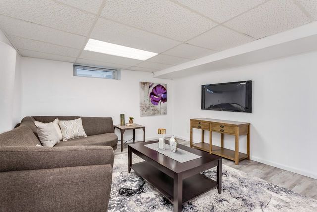 7500 Beckwith Road Morton Grove, IL 60053 - Photo 24 of 27 a living room with furniture and a flat screen tv