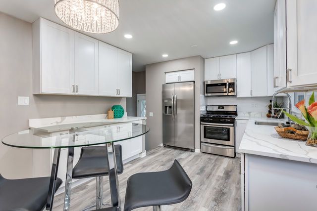 7500 Beckwith Road Morton Grove, IL 60053 - Photo 5 of 27 a kitchen with stainless steel appliances granite countertop a sink refrigerator and cabinets