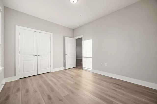 a view of an empty room with wooden floor