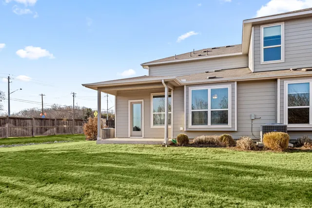 a front view of house and yard with green space
