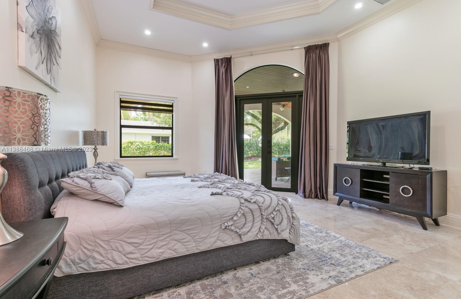 6874 Southwest 57th Terrace Miami, FL 33143 - Photo 13 of 36 a bedroom with a bed a window and dresser