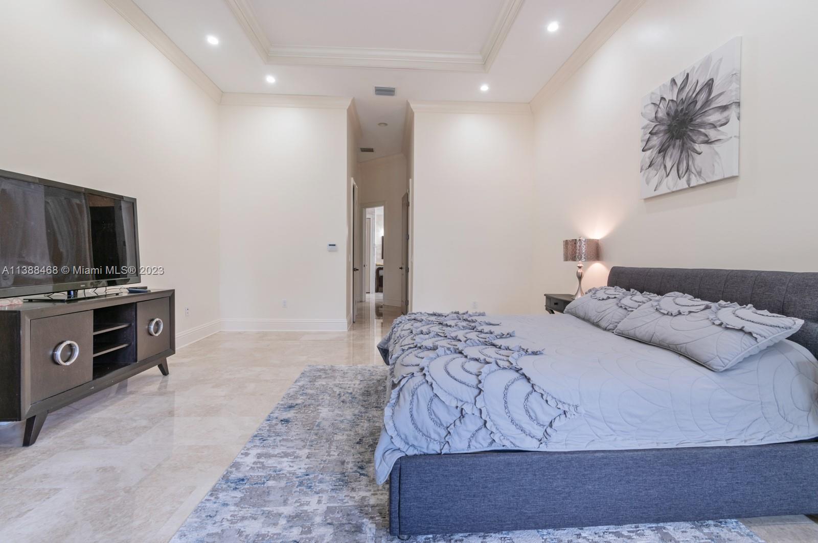 6874 Southwest 57th Terrace Miami, FL 33143 - Photo 14 of 36 a bedroom with a bed and a television in it