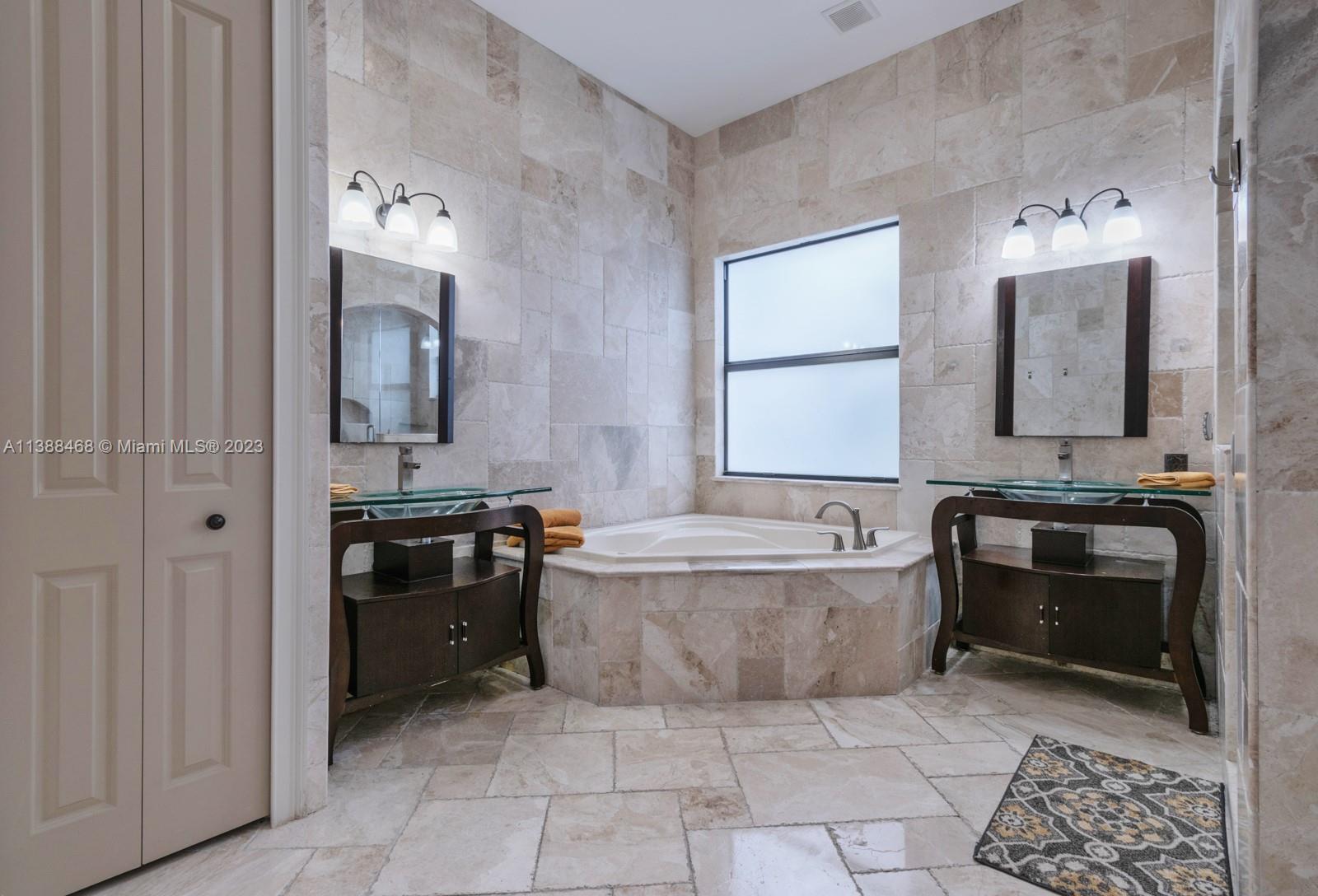 6874 Southwest 57th Terrace Miami, FL 33143 - Photo 15 of 36 a bathroom with a bathtub sink and mirror