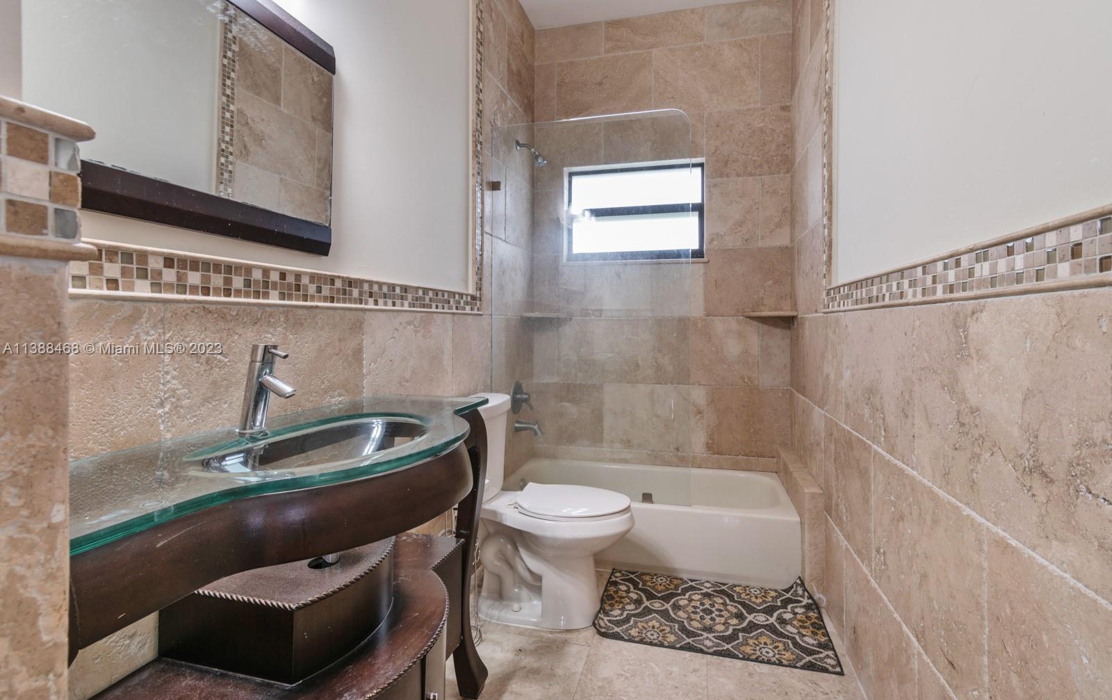 6874 Southwest 57th Terrace Miami, FL 33143 - Photo 20 of 36 a bathroom with a toilet a sink and bathtub