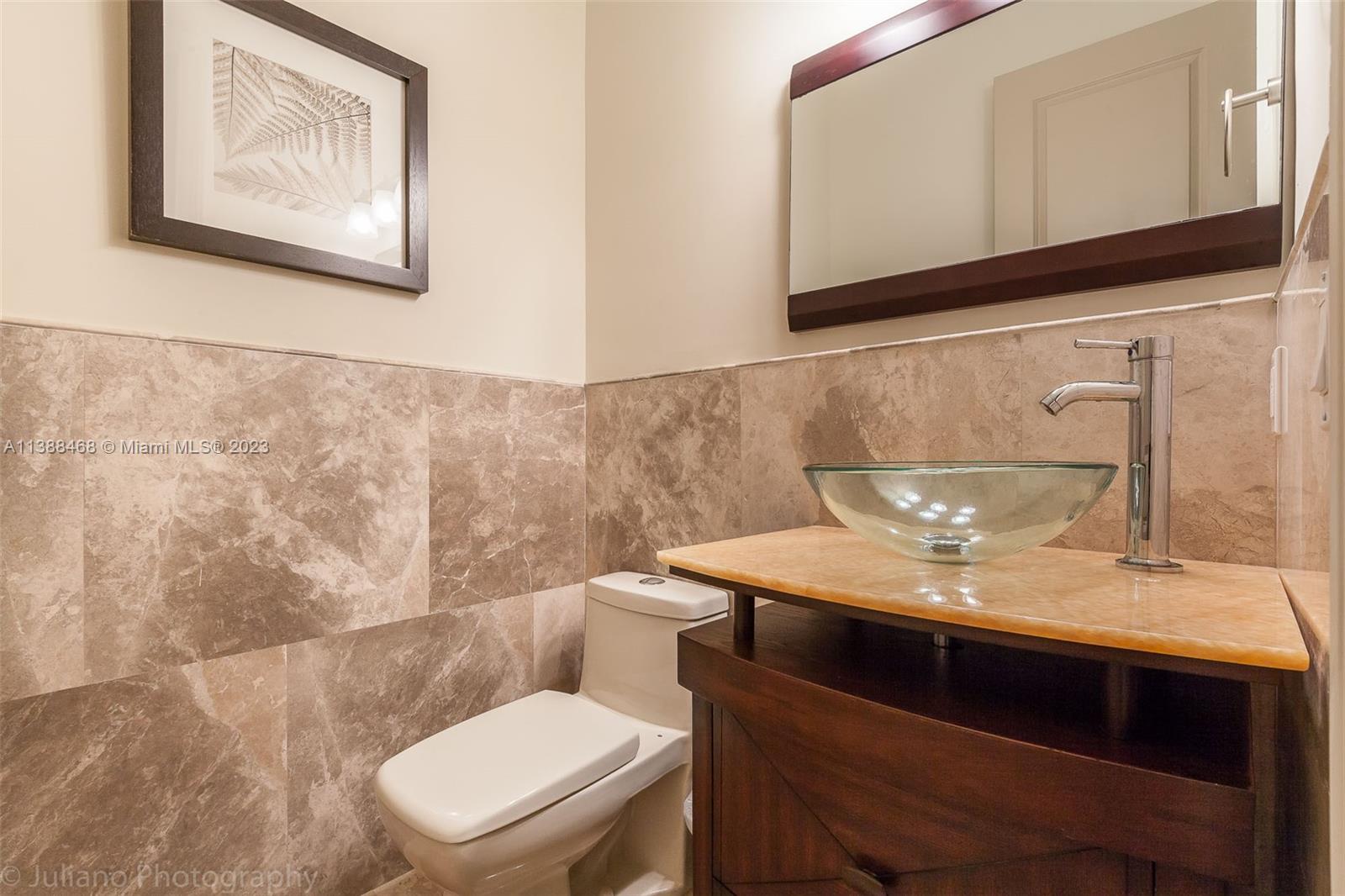 6874 Southwest 57th Terrace Miami, FL 33143 - Photo 25 of 36 a bathroom with a toilet a sink and mirror