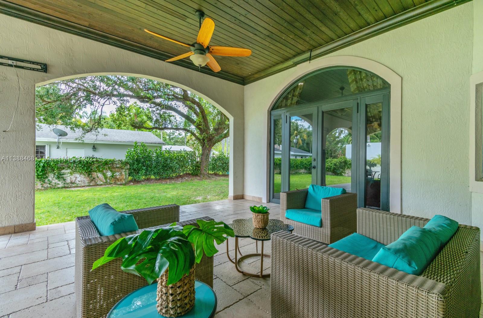 6874 Southwest 57th Terrace Miami, FL 33143 - Photo 34 of 36 a view of a patio with couches chairs and a yard