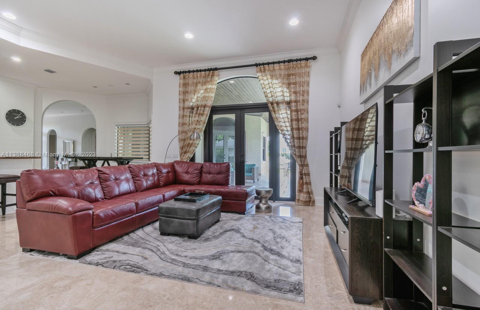 6874 Southwest 57th Terrace Miami, FL 33143 - Photo 9 of 36 a living room with furniture fireplace and a flat screen tv