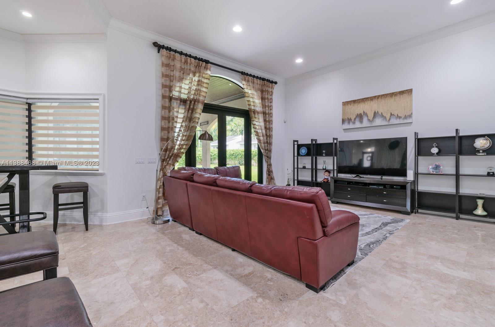 6874 Southwest 57th Terrace Miami, FL 33143 - Photo 10 of 36 a living room with furniture and a flat screen tv