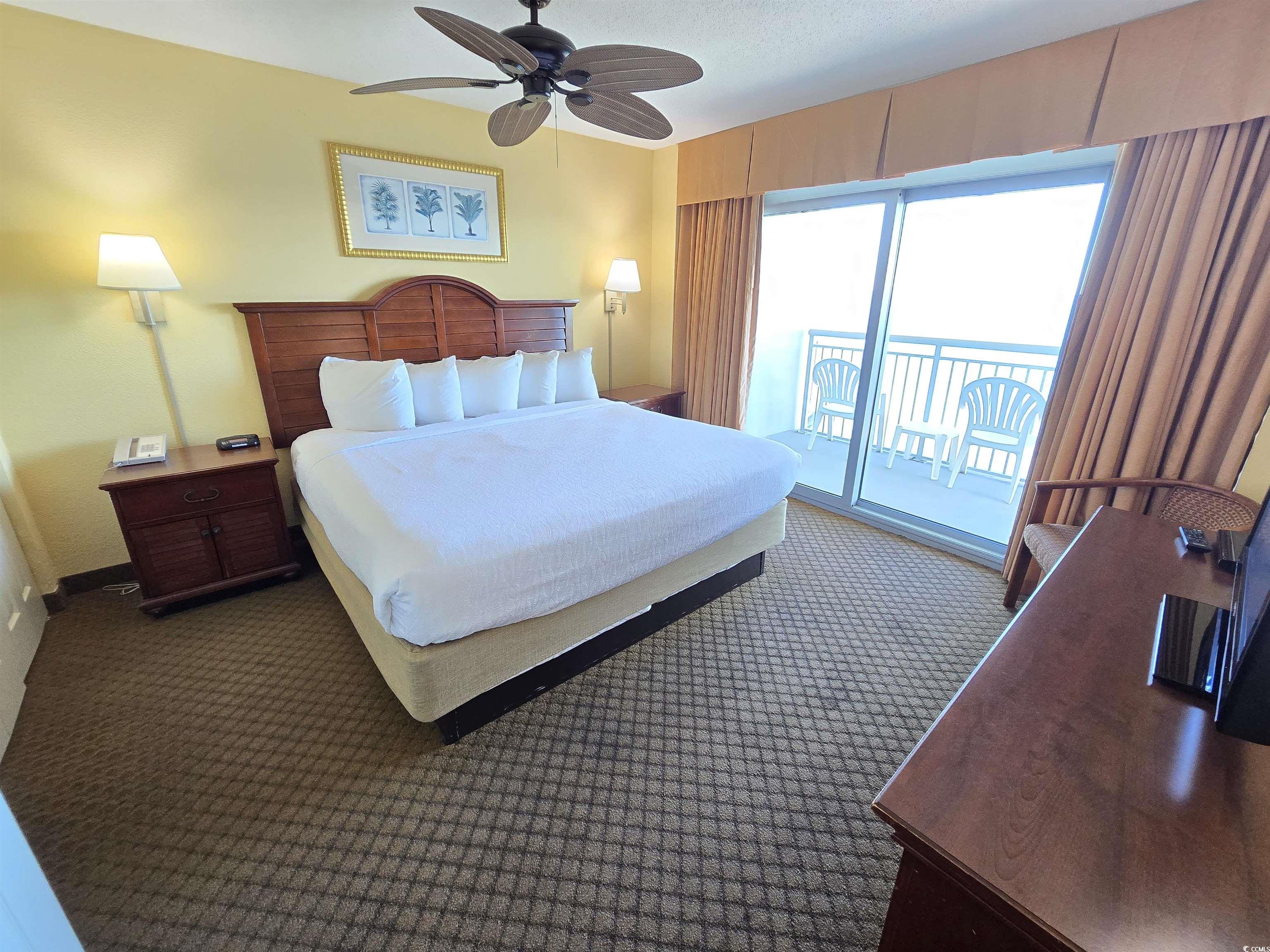 2007 South Ocean Boulevard, Unit 1607 Myrtle Beach, SC 29577 - Photo 9 of 31 Bedroom with carpet flooring, access to exterior, and a ceiling fan