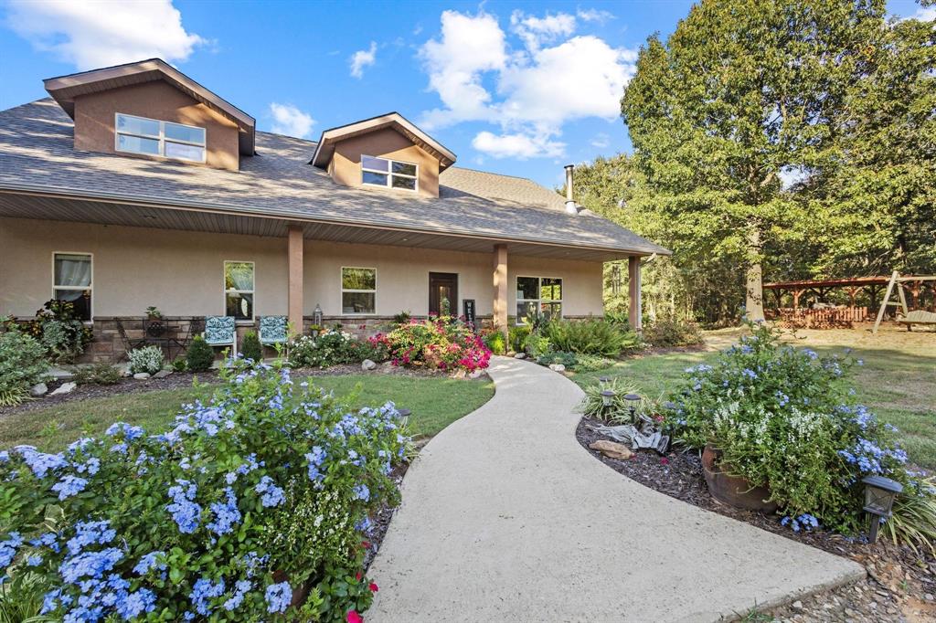 a front view of a house with a yard and outdoor seating