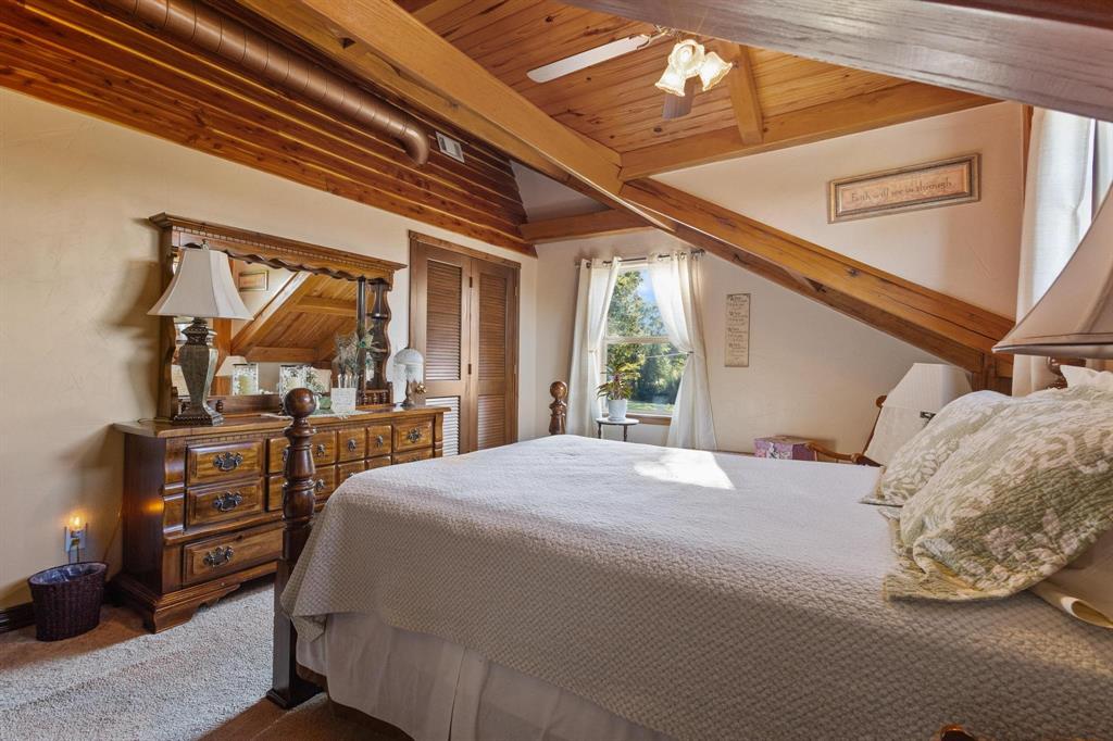 312 County Road 2100 Detroit, TX 75436 - Photo 15 of 39 a bedroom with a bed and a flat tv screen on the dresser