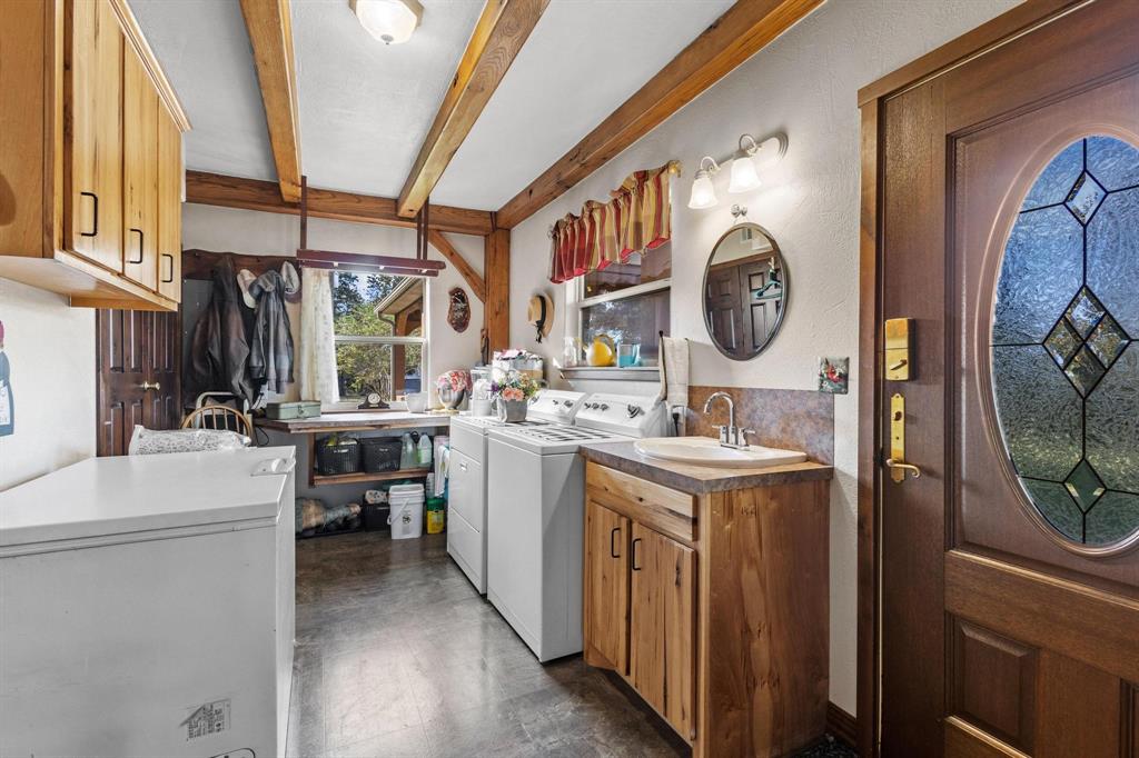 312 County Road 2100 Detroit, TX 75436 - Photo 18 of 39 a kitchen with a sink a stove top oven and washer