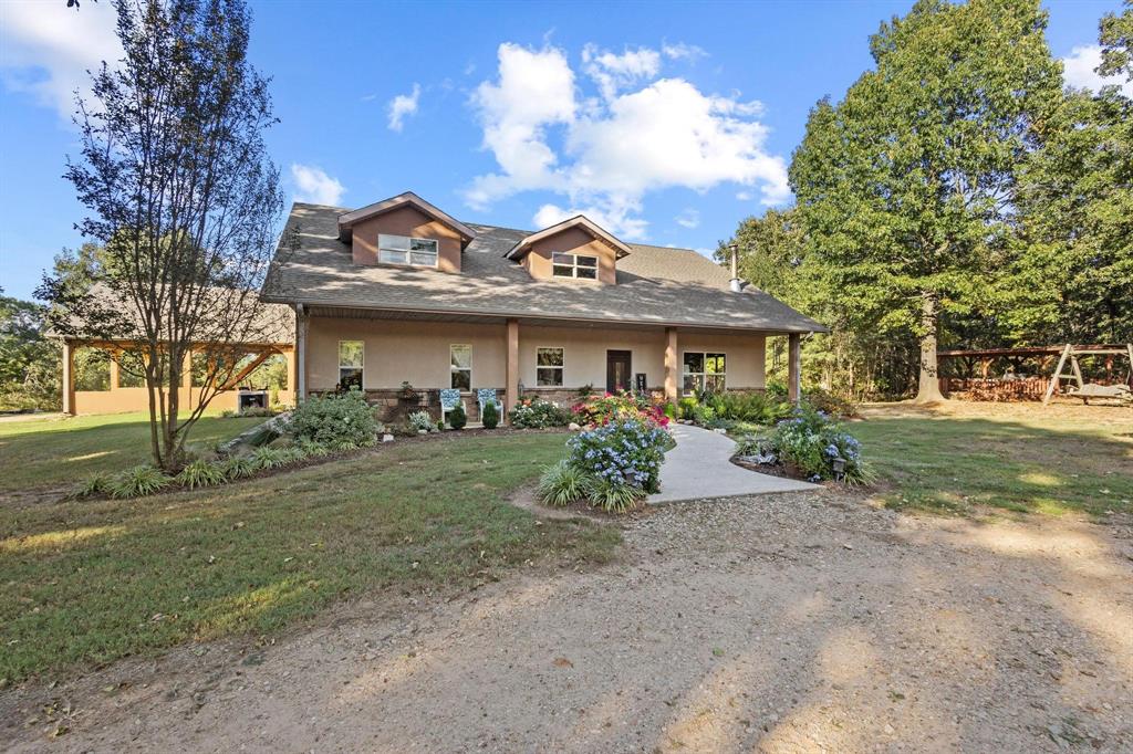 312 County Road 2100 Detroit, TX 75436 - Photo 2 of 39 a front view of a house with garden