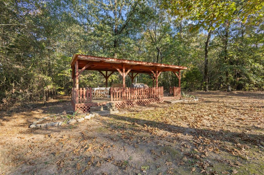 312 County Road 2100 Detroit, TX 75436 - Photo 24 of 39 a view of a wooden deck with a trees