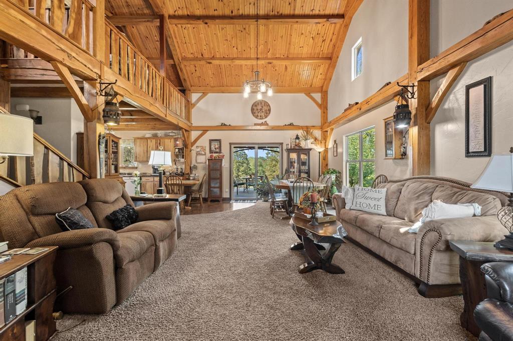 312 County Road 2100 Detroit, TX 75436 - Photo 9 of 39 a living room with furniture a chandelier and a large window