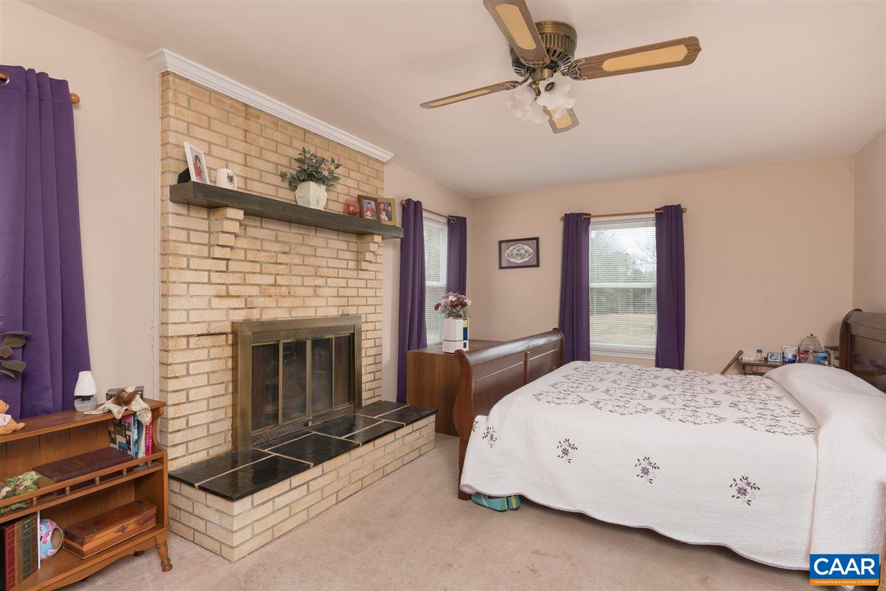 706 Zion Road Zion Crossroads, VA 22942 - Photo 12 of 38 a bedroom with a bed and a fireplace