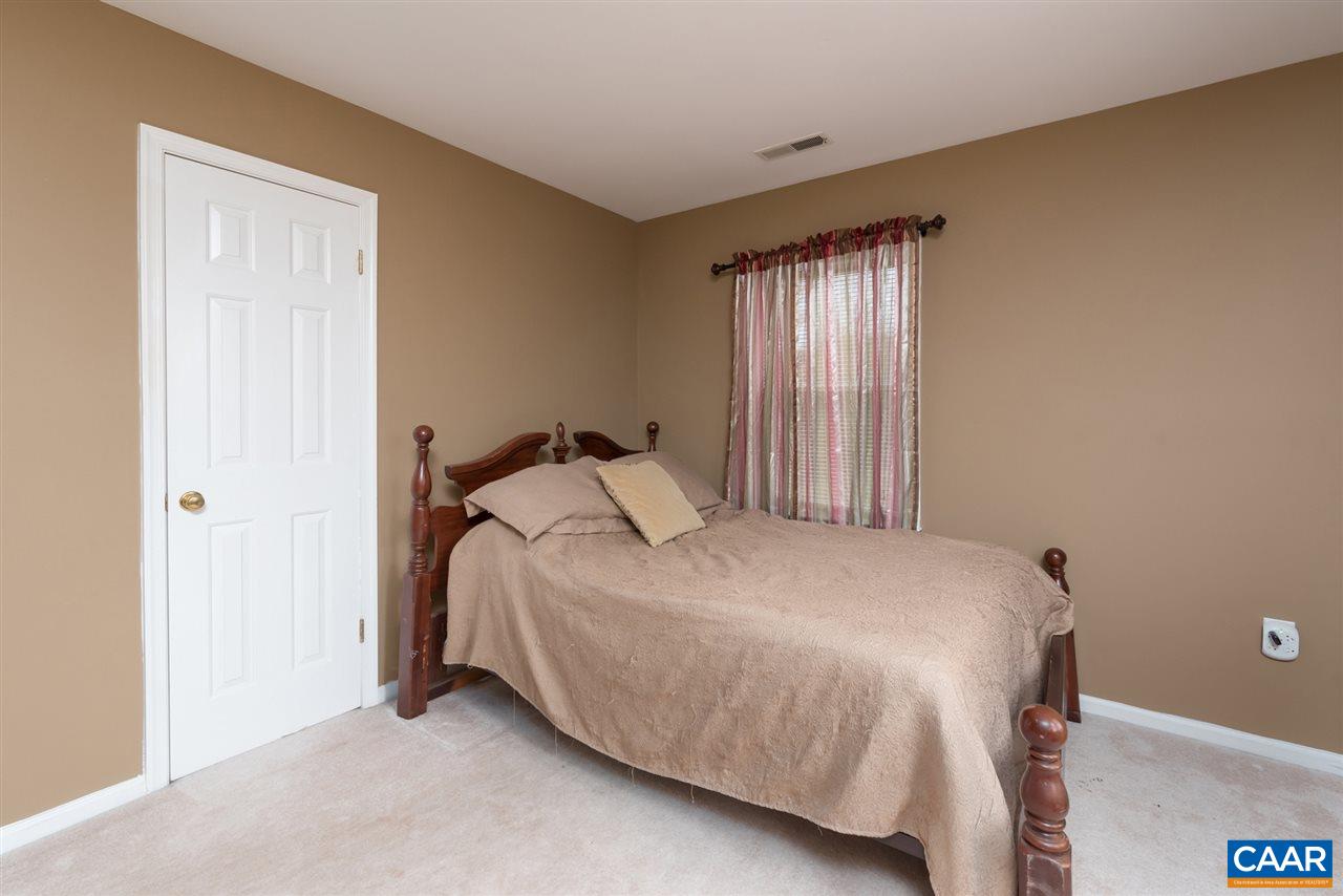 706 Zion Road Zion Crossroads, VA 22942 - Photo 27 of 38 a bed sitting in a bedroom next to a window