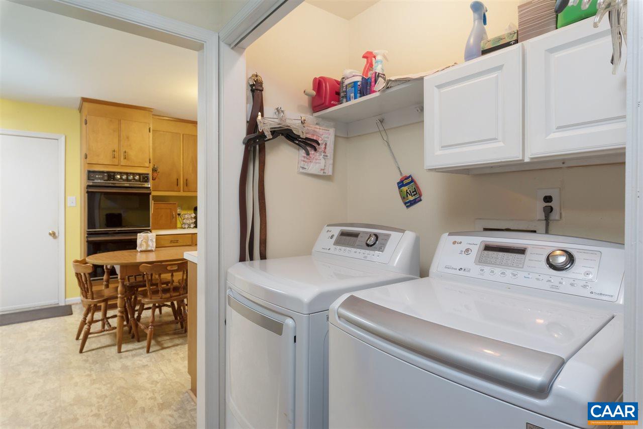 706 Zion Road Zion Crossroads, VA 22942 - Photo 10 of 38 a utility room with dryer washer and a view of living room