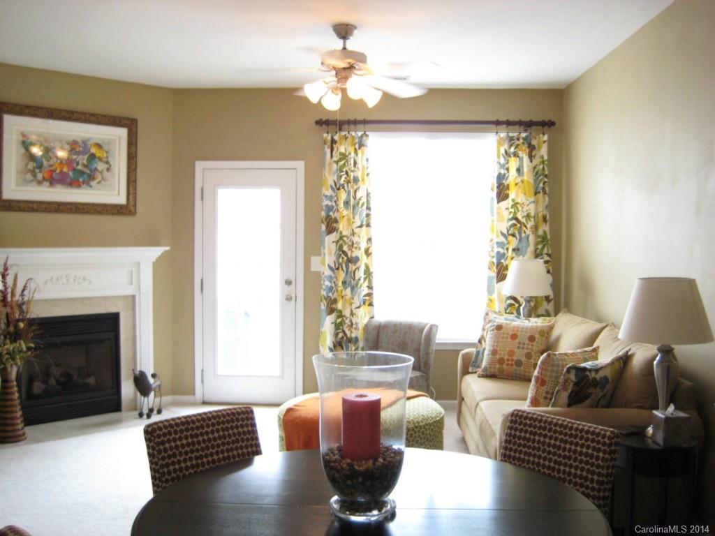 334 Sugar Ridge Court, Unit 102 Fort Mill, SC 29708 - Photo 2 of 18 a living room with furniture chandelier and a fireplace
